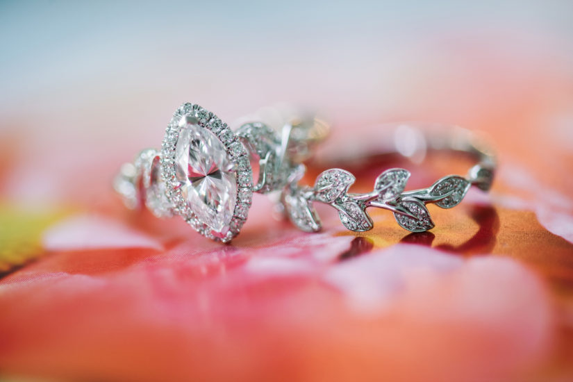 Engagement ring and wedding band with a leaf design and a marquise diamond in white gold by Kirk Kara