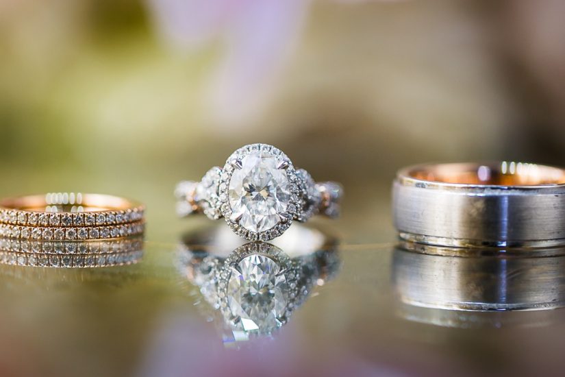 Beautiful set of Kirk Kara engagement and wedding rings on a reflective background