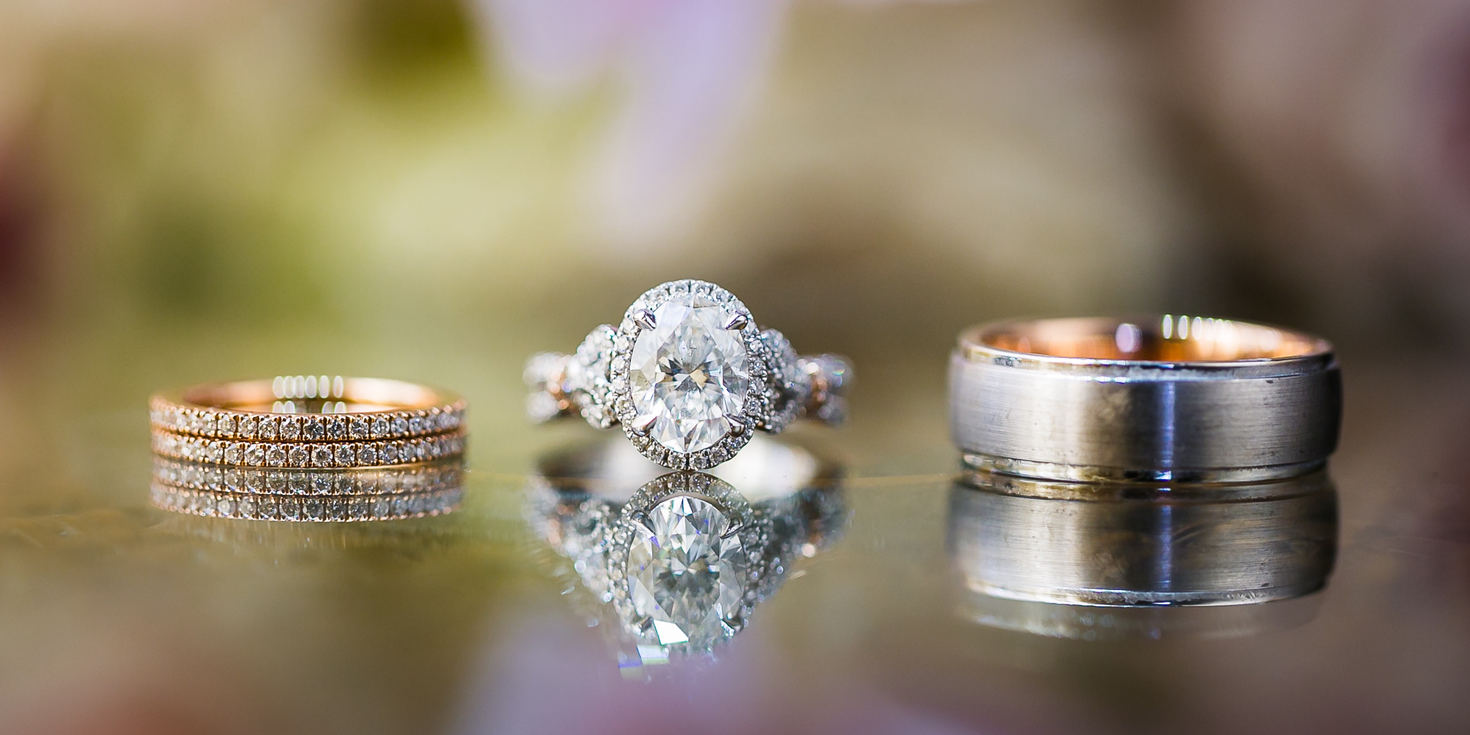 Beautiful set of Kirk Kara engagement and wedding rings on a reflective background