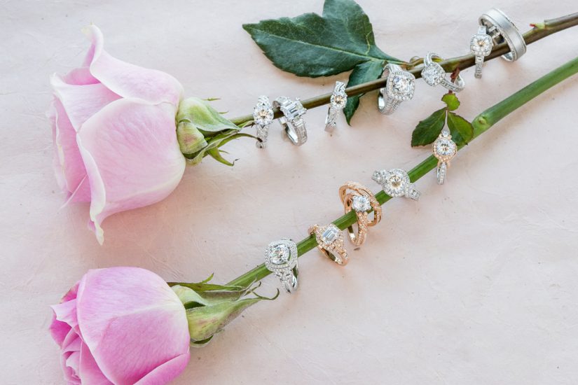 Kirk Kara's ten time Jewelers Choice award winning rings displayed on pink roses