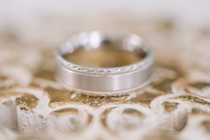 Men's wedding band in white gold on a swirling rose gold background