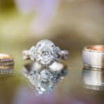 Beautiful set of Kirk Kara engagement and wedding rings on a reflective background