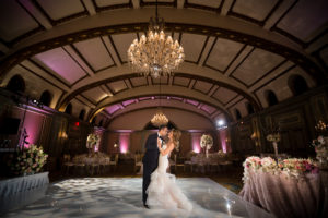 Bride & groom dancing at their reception with no one else in the room