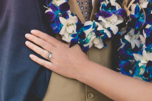 Kirk Kara engagement and wedding rings with blue lei at Hawaiian Wedding