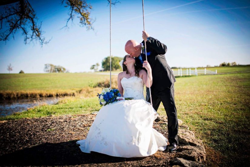 Photoshoot of couple kissing in a field